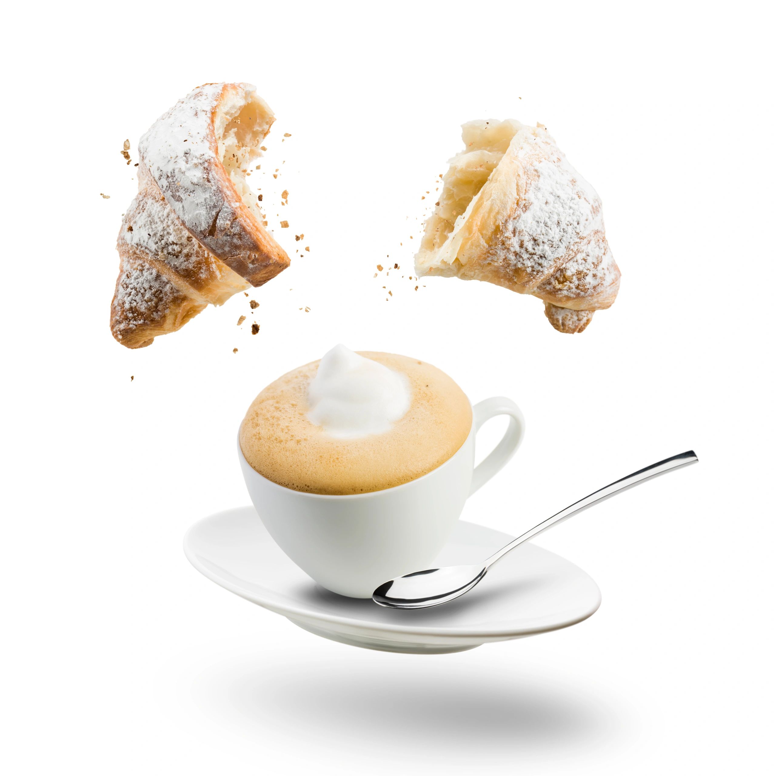 Cappuccino and croissant arranged for an elegant breakfast setting