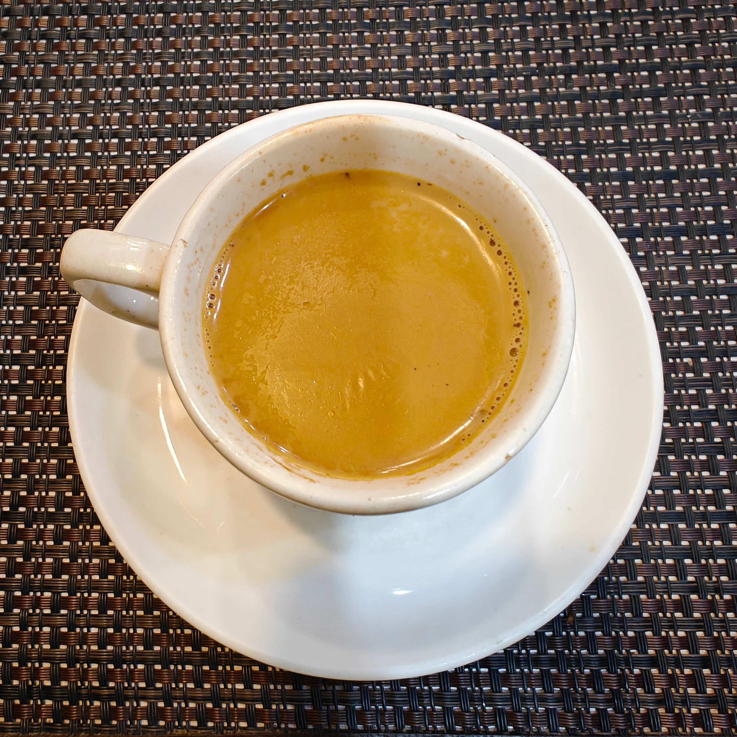 Top view of a cup of coffee in a clean refined composition