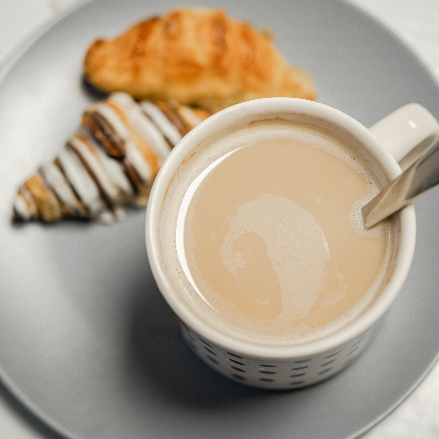 Latte and croissant styled as a refined café moment